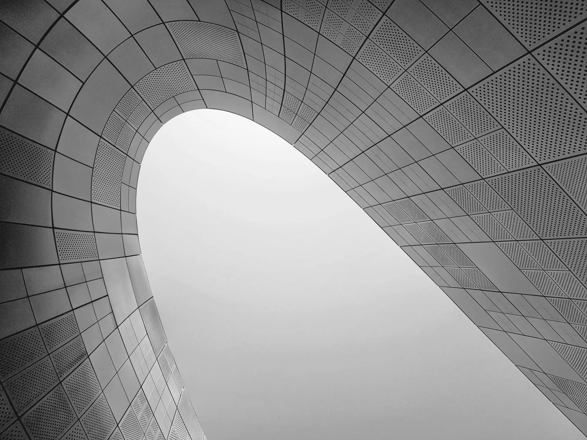 A curved architectural canopy in black and white