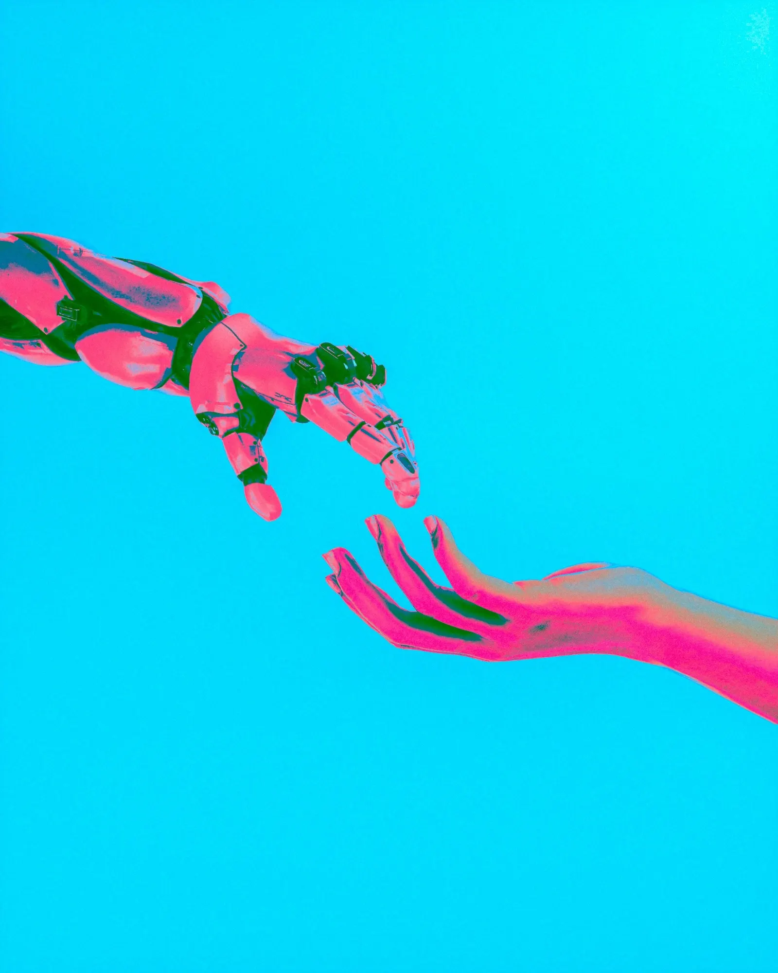 A robotic hand and a human hand reaching towards each other