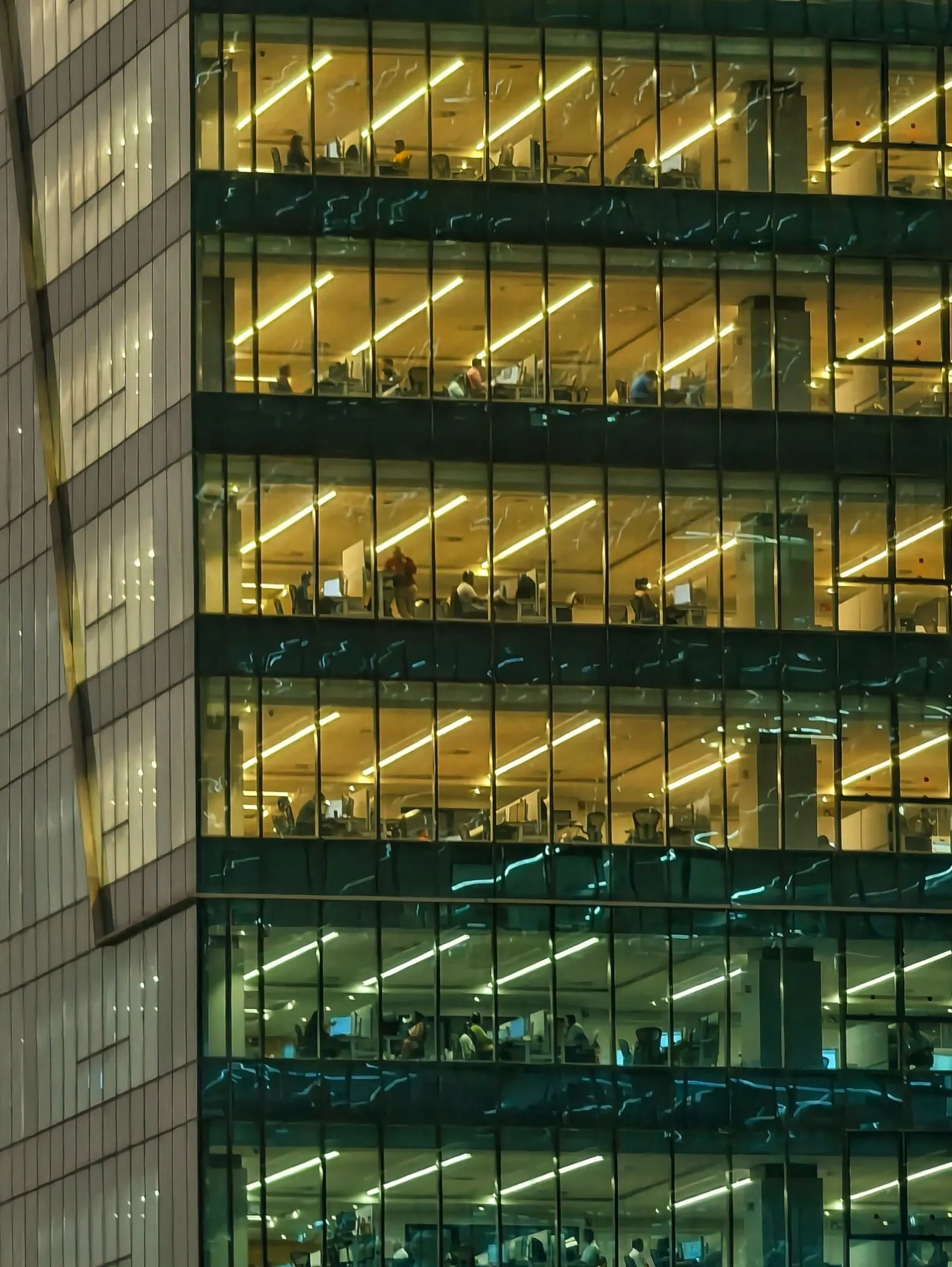 Office floors lit up at night, with people at work